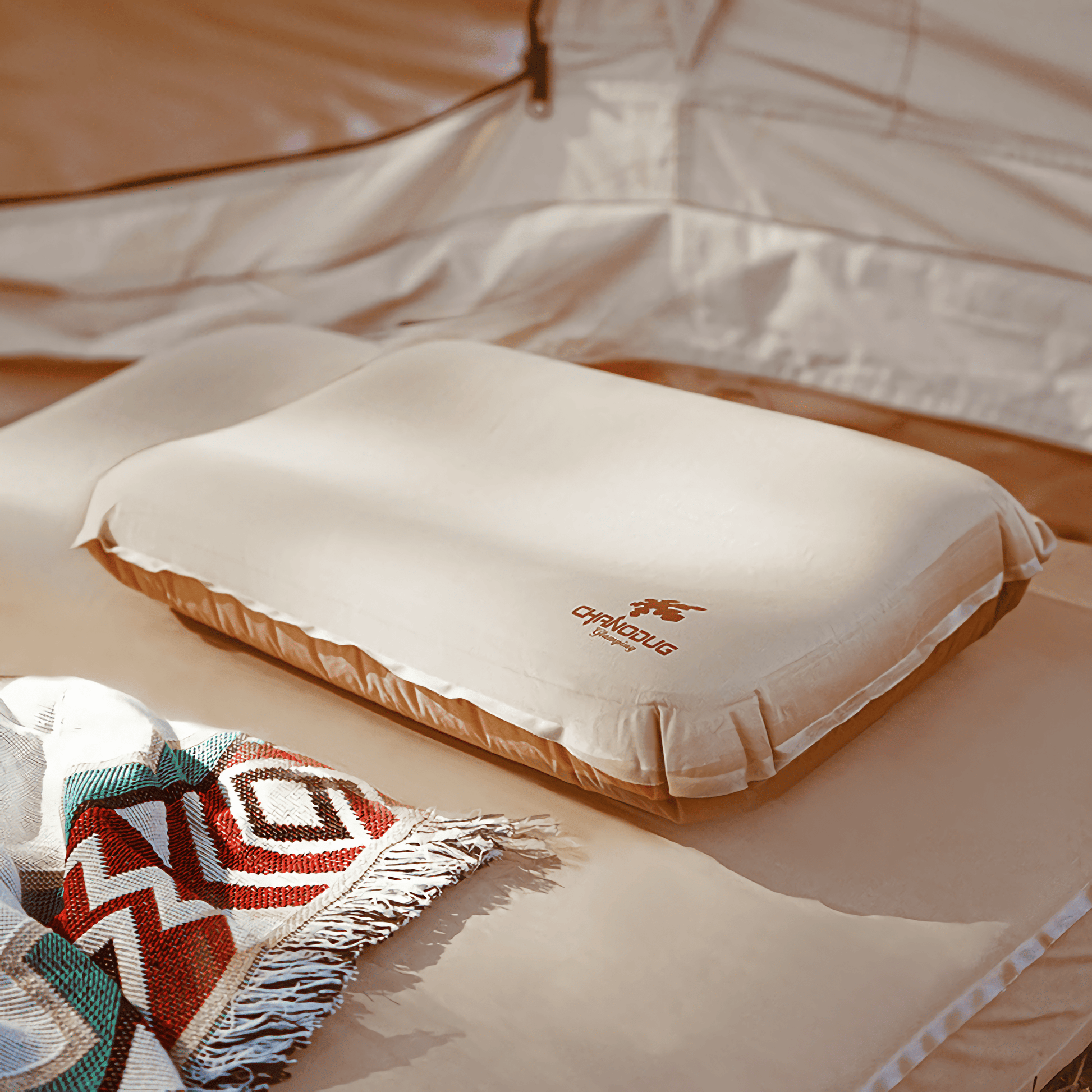 Image: A compact and lightweight inflatable camping pillow, perfect for outdoor adventures. This portable travel cushion provides essential sleep support for backpacking and camping. Explore the comfort and convenience of our innovative camping gear pillow.