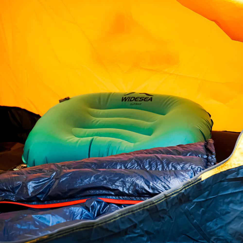 Elevate your outdoor comfort with our Mini Light Portable Pillow, displayed in a camping scene. Soft and plush, it's the perfect accessory for campers and hikers seeking a compact and lightweight solution.