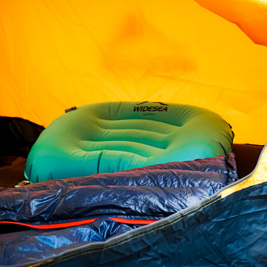 Elevate your outdoor comfort with our Mini Light Portable Pillow, displayed in a camping scene. Soft and plush, it's the perfect accessory for campers and hikers seeking a compact and lightweight solution.