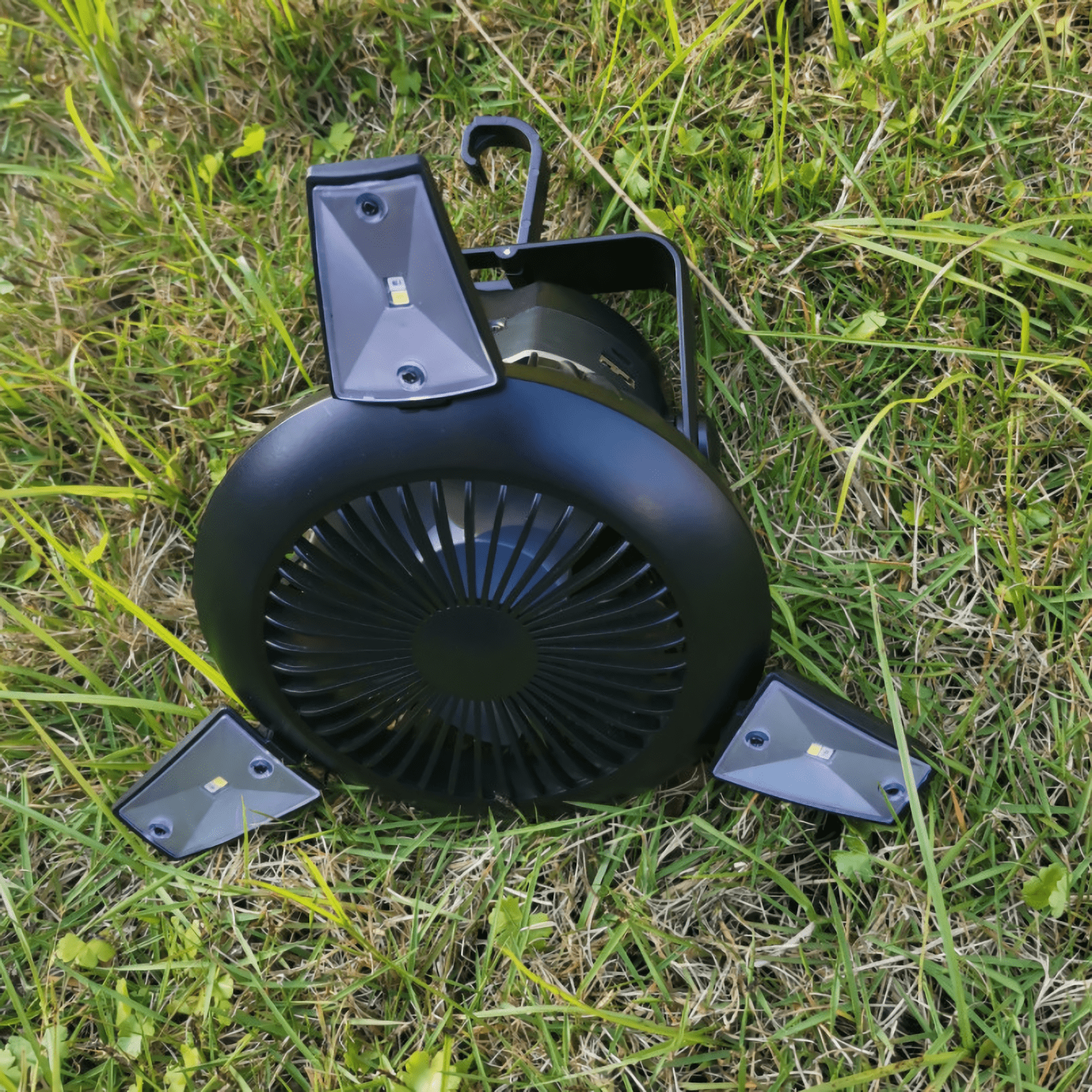 Portable camping accessory with adjustable fan speed and lighting modes.